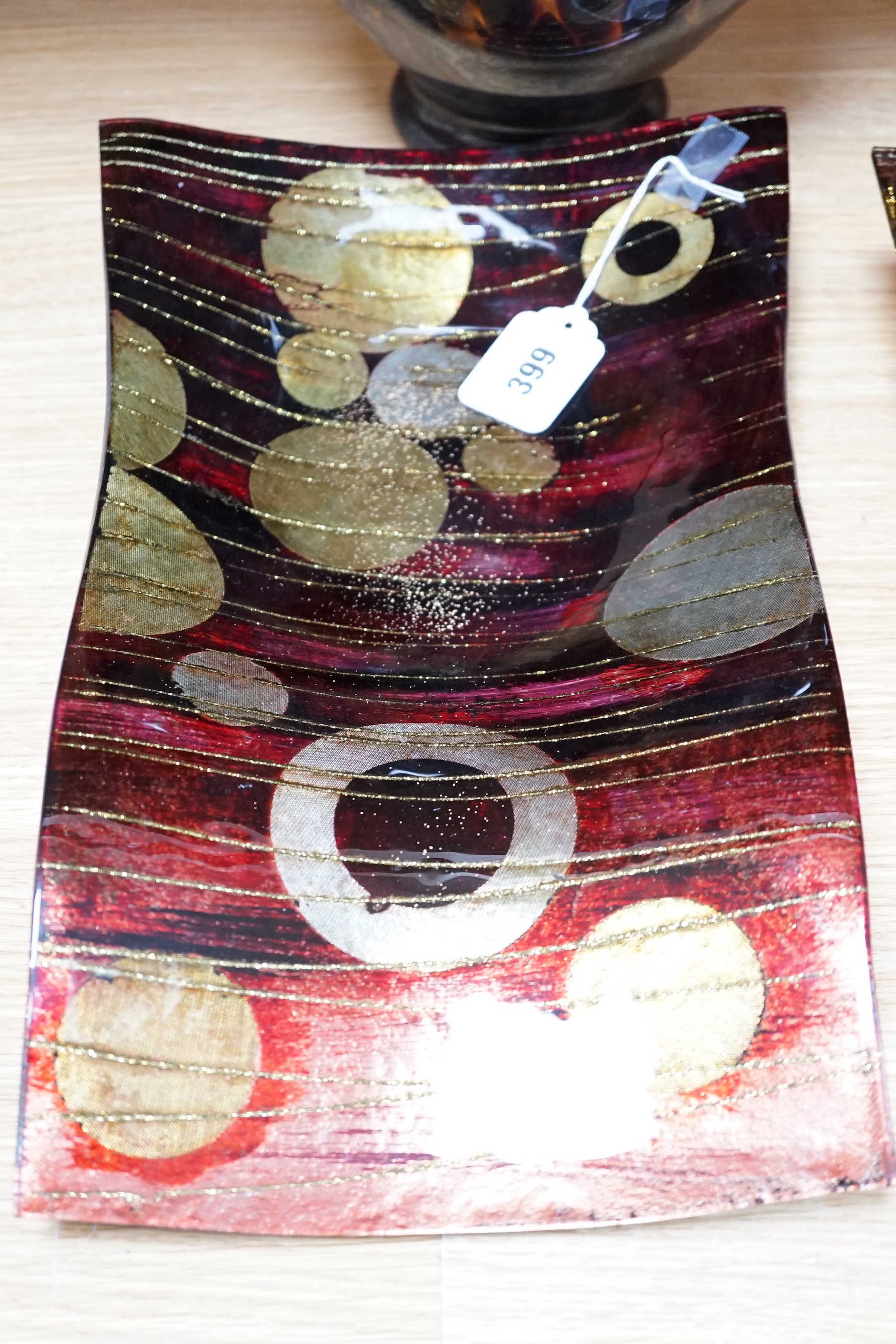 A faux tortoiseshell glass vase, an art glass vase and two Art glass dishes, the largest 41cm wide